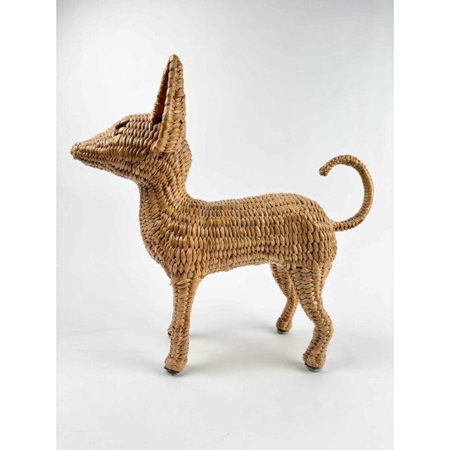 A charming Mario Lopez Torres Chihuahua sculpture made of woven wicker and metal bead eyes. A metal frame was used to...