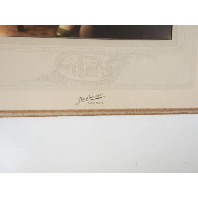 Vintage circa 1920's hand tinted glamour photograph portrait of seated young woman in green and pink gown. Steinheimer...