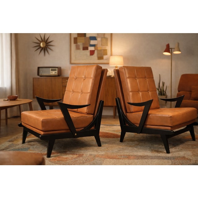 A superb pair of vintage armchairs dating from the 1950s, boasting a distinctly modernist design and elegant presence....