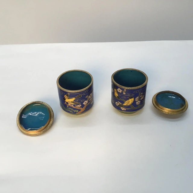 Cute pair of small lidded jars. Cobalt blue on the outside , turquoise enamel interior . Birds and blossoms motifs ....