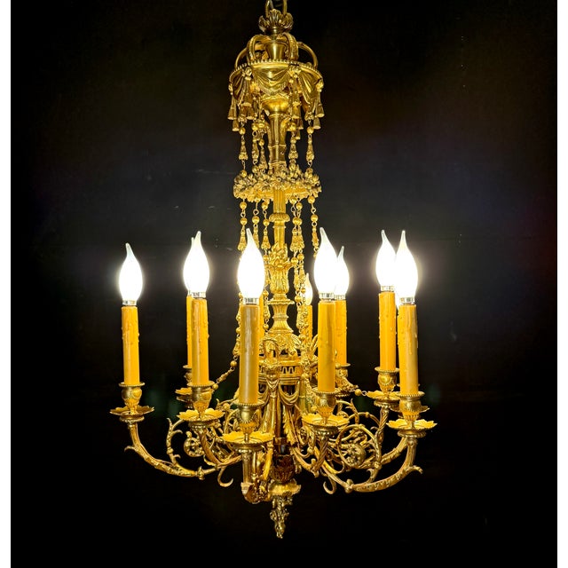 An outstanding French 19th-century Louis XVI–style gilt bronze twelve-light chandelier, richly cast with superb...