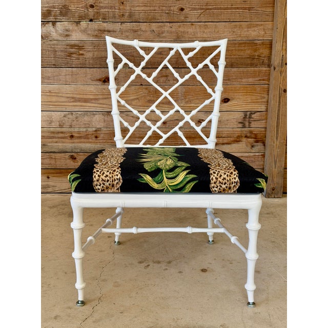 A fabulous vintage faux bamboo lounge side chair by Phyllis Morris, featuring an elegant geometric lattice back and...