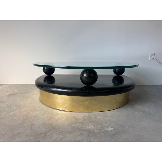 A striking 1980’s Postmodern coffee table featuring a sculptural half-moon design that perfectly captures the era’s bold...