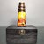 This is a striking, vintage-style single-tube telescope, presented in a dark, distressed wooden storage box. The telescope...