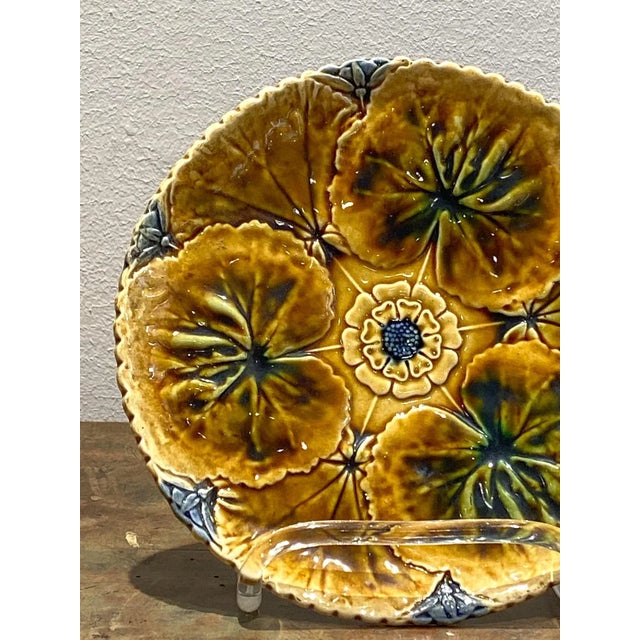 A 19th-century English majolica multi-colored glazed plate with lily pads.
