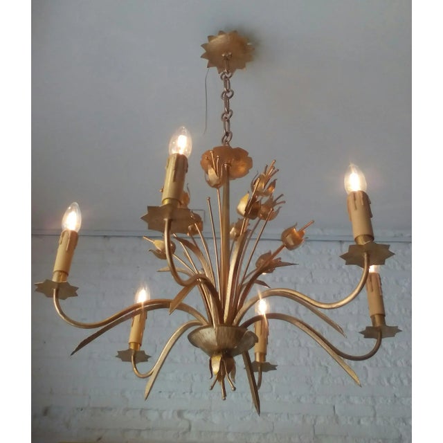 This French lamp from the 1950s features plant motifs and has been restored and refinished in a soft gold. The piece...