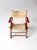 A vintage children’s folding chair with a wood frame and classic beach or camp-style design. The seat and back are...