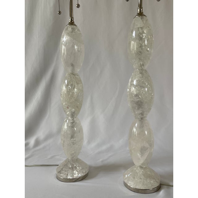 Pair of hand carved solid rock crystal lamps with three stacked oval crystals and circular crystal cones, set in polished...
