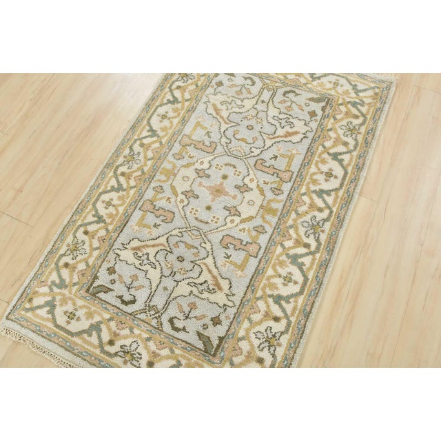 This modern traditional tribal Oushak rug is hand-knotted with an all-wool pile on a cotton foundation. This rug is new...