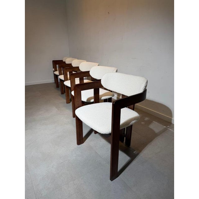 Noma Walnut Dining Chairs in Bouclé Fabric. Elegant dining chairs featuring a solid walnut frame combined with a soft,...