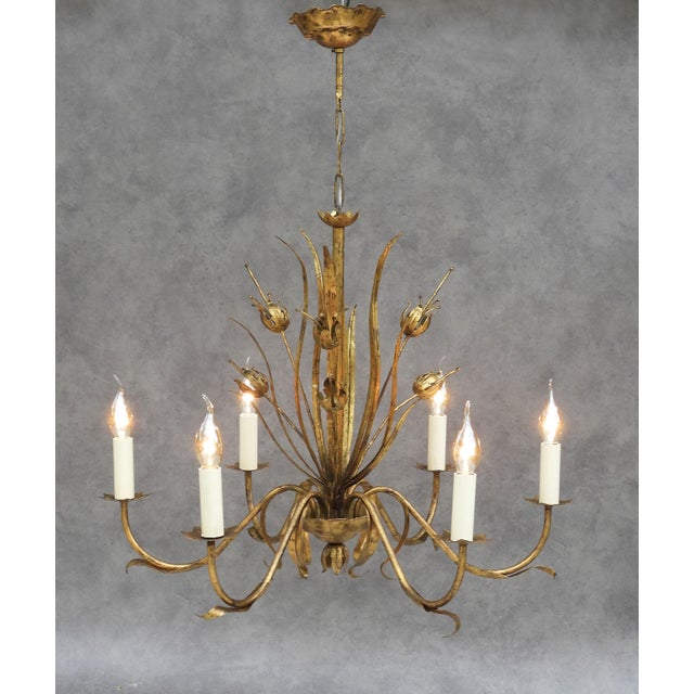 A striking mid-century Spanish gilt tôle chandelier featuring an elegant botanical design. The sculptural composition...