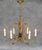 A striking mid-century Spanish gilt tôle chandelier featuring an elegant botanical design. The sculptural composition...