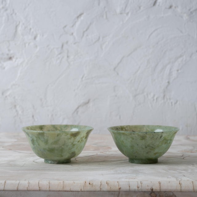 A pair of Chinese spinach jade bowls, circa 1920s. 4 inches wide by 1 ¾ inches tall