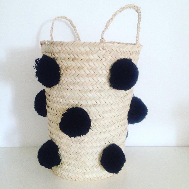 This cute pompom basket is hand-woven with straw and wool (pompoms) by local artisans in Marrakesh, it is perfect as a...