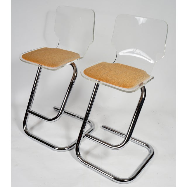 This is a set of Luigi Bardini mid-century Lucite and chrome bar stools for Hills Manufacturing. Perfect for a kitchen...