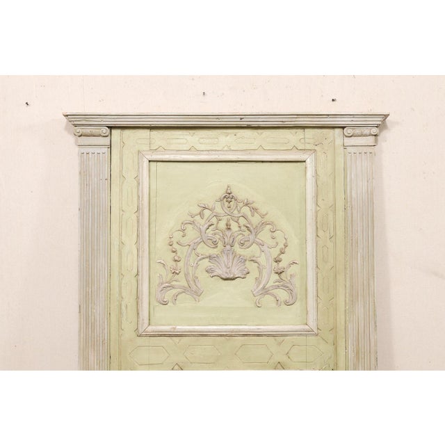 A large-sized Italian carved and painted wood trumeau style mirror from the 19th century. This antique mirror from Italy...