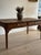A long English farm table in pine, gone a deep honeyed brown on the plank top with the old chatter and splits you want in...