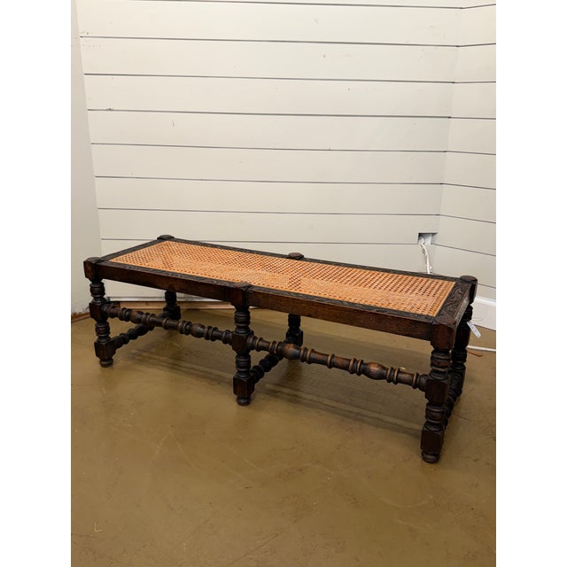 This is such a versatile English Jacobean Revival long bench. It features a woven can seat supported with intricately...