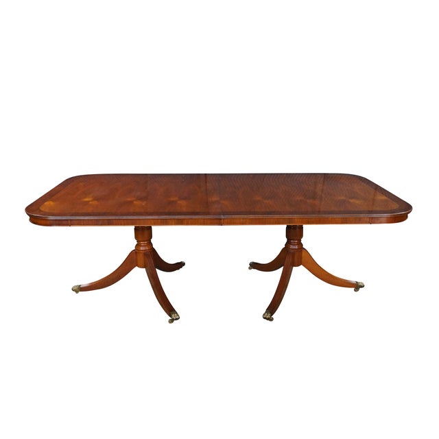 This exceptional, late 20th century handmade English Regency / Duncan Phyfe style double-pedestal dining table offers a...