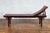A Chinese Qing Dynasty period elm wood reclining lounge chair from the 19th century with bamboo slats and cloud-themed...