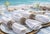 Elevate your table setting with this set of four genuine cowrie shell napkin rings, each crafted from naturally patterned...