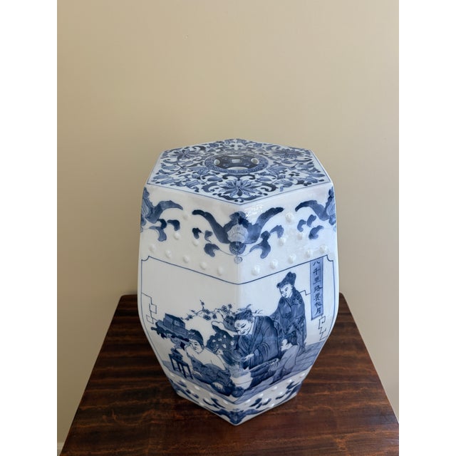A classic blue and white porcelain garden stool, decorated with traditional Chinese motifs and stylized floral elements....