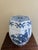 A classic blue and white porcelain garden stool, decorated with traditional Chinese motifs and stylized floral elements....