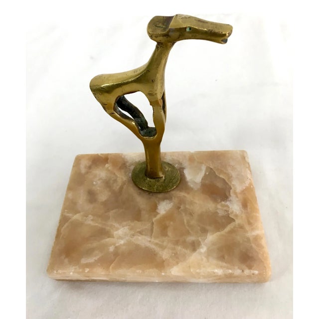 Unique marble and brass sculptural paper weight of a dog or animal.