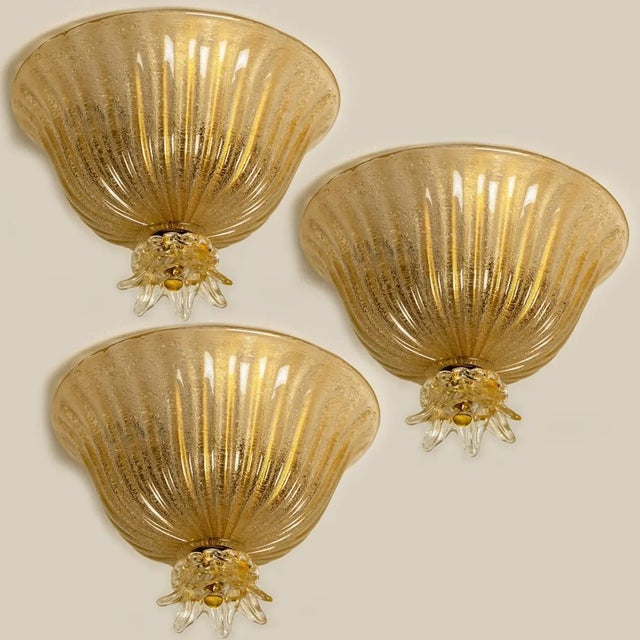 An elegant blown Murano glass flushmount by Barovier & Toso. The light fixture is made of thick Murano glass with gold...