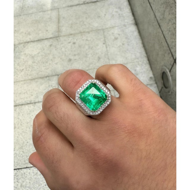 GRS certified 9.54 carat insignificant oil Colombian emerald and diamond mens ring. Featuring a round cut diamond halo and...