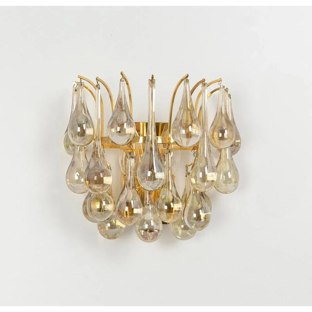 A stunning pair of golden sconces, made by christoph palme, germany, circa 1970-1979. It’s composed of murano teardrop...
