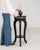 This piece presents as a pedestal stand, distinguished by black wood, turned column, small round top. Dating to 1880s and...