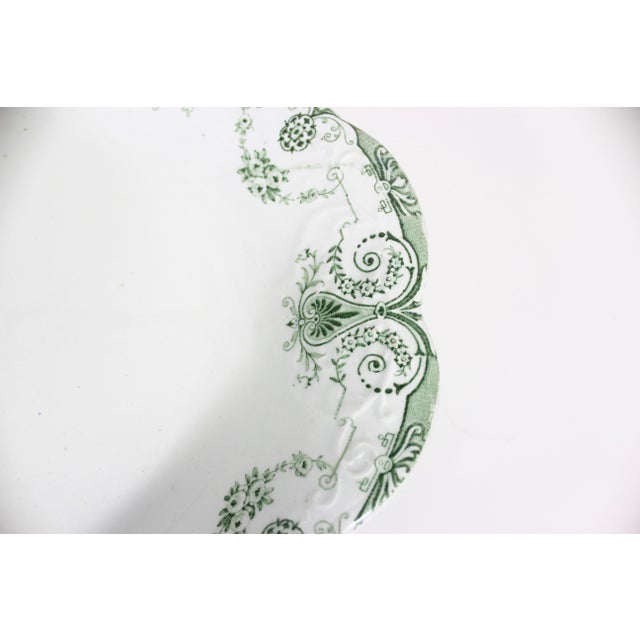 Vintage, or possibly antique oval transferware platter with a green floral pattern. It has a raised embossed design on the...