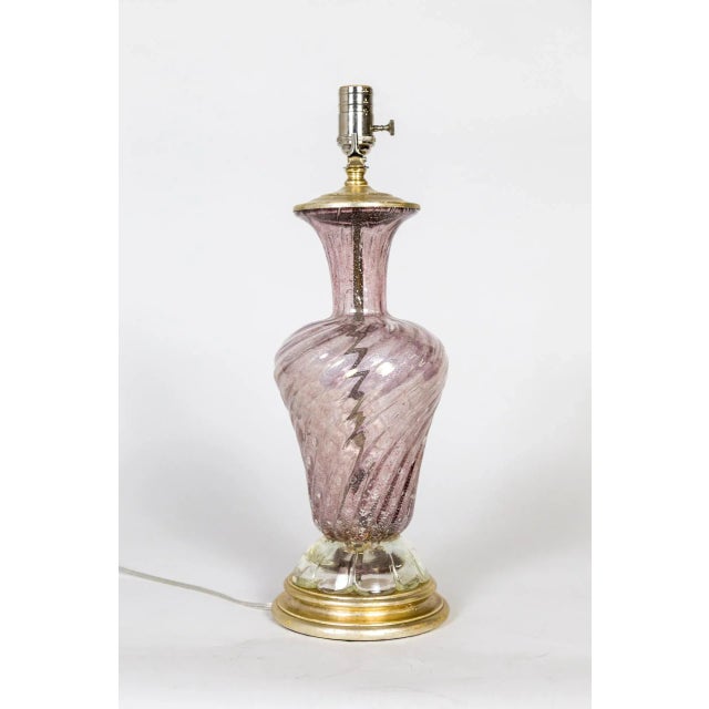 A Murano glass lamp swirled into an urn shape with scalloped bottom in transparent dusty rose color with silver flecks;...
