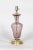 A Murano glass lamp swirled into an urn shape with scalloped bottom in transparent dusty rose color with silver flecks;...