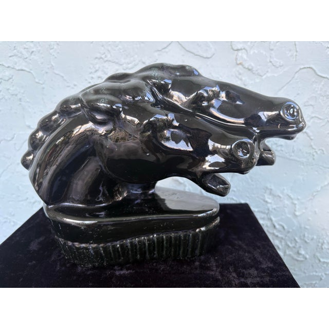 This striking vintage ceramic table lamp features two sculptural horse heads emerging in a bold, forward-facing...
