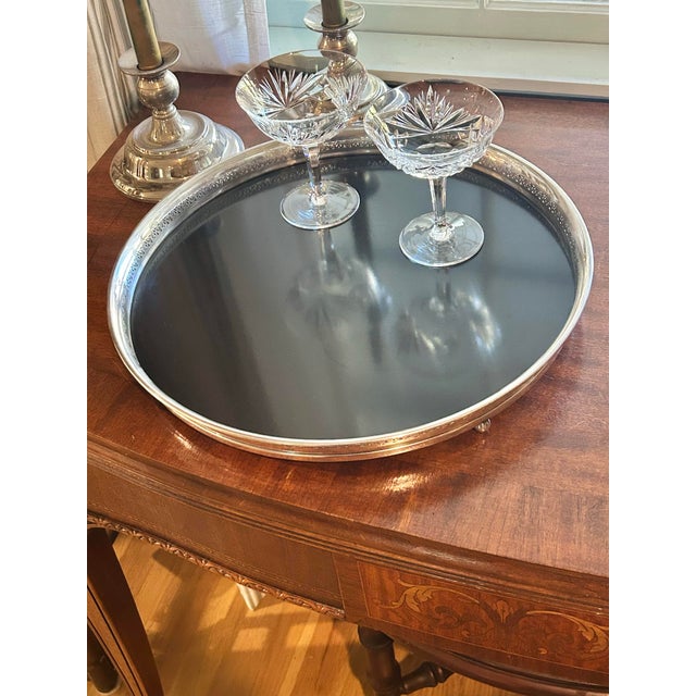 This is a vintage Crescent Silverware serving tray featuring a silverplated pierced gallery, rounded rim and petite ball...