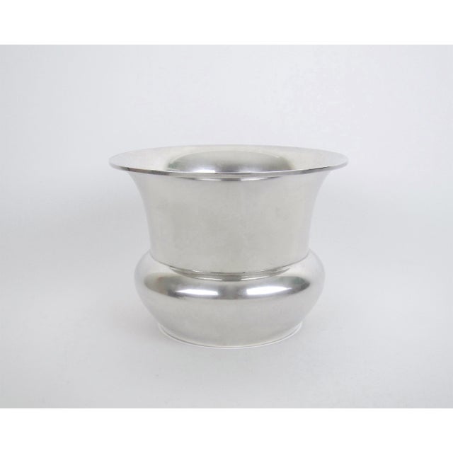 An American sterling silver vase with a flaring rim by Marie Zimmermann (1879-1972), a noted metalsmith, jeweler and...