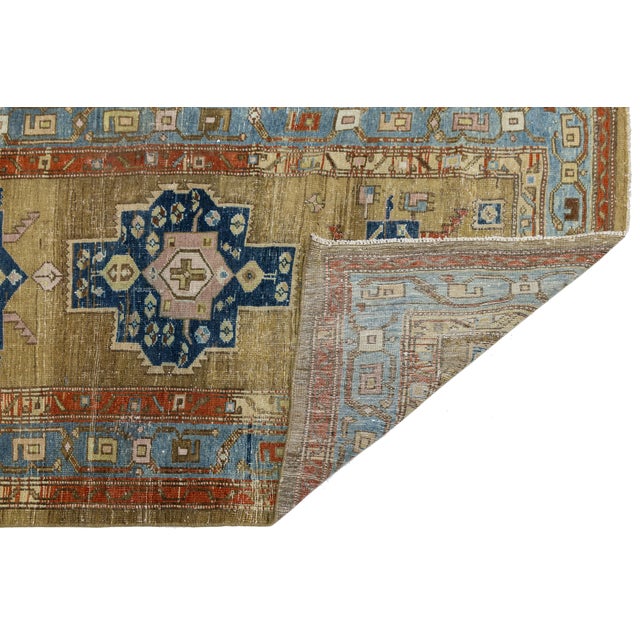 An exceptional antique Heriz runner rug featuring a rare, sought-after muted camel and golden-ochre field. Artfully hand-...