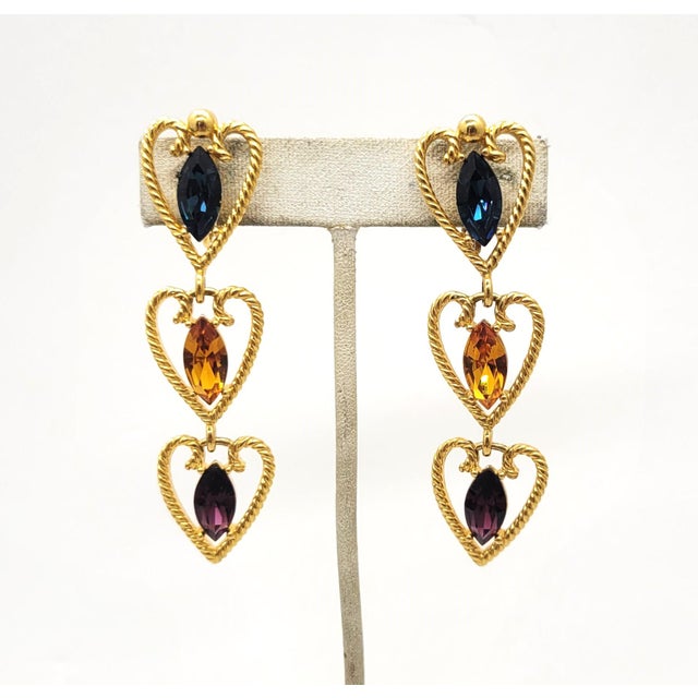 This is part of Chairish’s Costume Jewelry assortment. Goldtone 3 wired heart shapes with a marquise faux-sapphire top,...