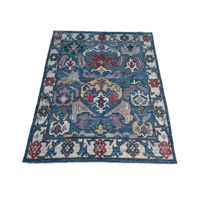 Bold large-scale floral design in the Sultanabad Mahal manner — oversized palmettes, split-leaf arabesques and curling...