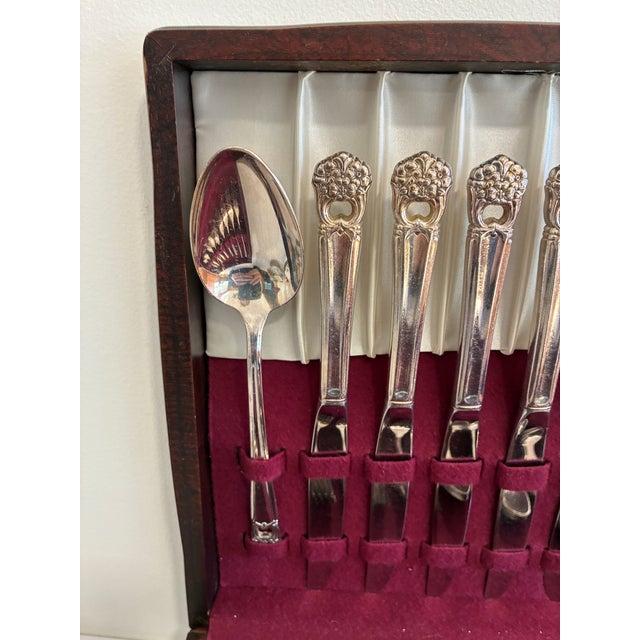 An elegant 52-piece silverplate flatware set by 1847 Rogers Bros in the Eternally Yours pattern. Floral ornament and...