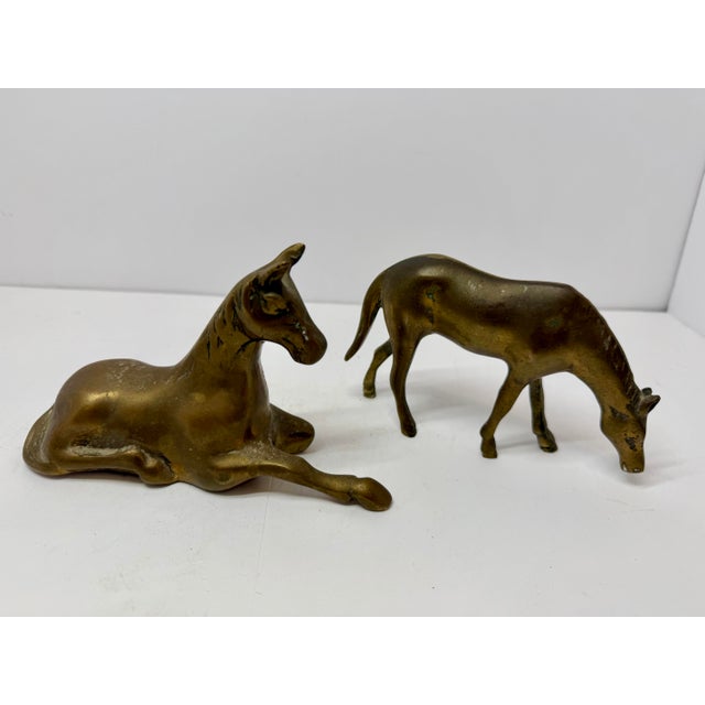 This vintage (c. 1970-1980) set features two solid brass horses in expressive poses: a resting mother mare and a...