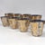 A striking Culver "Quadrille" barware set featuring the pattern's signature 22-karat gold decoration over smoky glass. The...