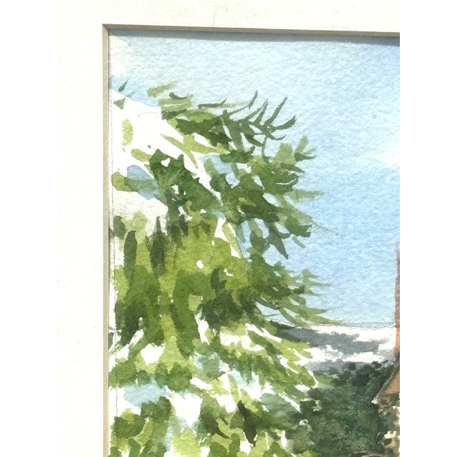 Her is a beautiful vintage watercolor painting of a brick cottage in the snow with a snowy pine tree in the foreground....