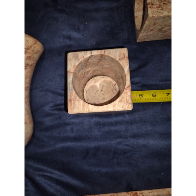 This is a vintage or mid-century modern carved pink marble decorative home and vanity accessory set featuring a small...