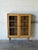 This attractive bookshelf features clean lines and an airy architectural profile. Twin glass doors showcase an elegant...