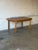 This extendable dining table features an oval top, scalloped apron details, and elegant turned legs. It includes three...