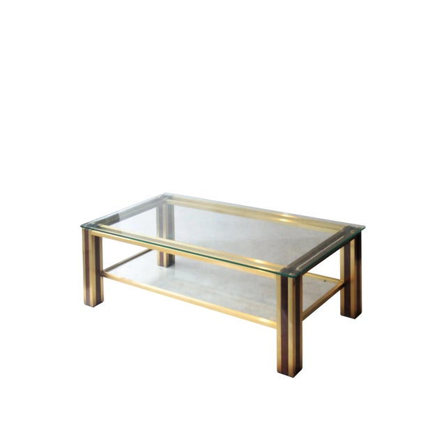 Coffee table with brass structure and solid wood with top and bottom shelf glass, brass details finished in a pyramidal...
