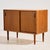 Danish teak cabinet with two sliding doors and one shelf inside, produced by Lyby Møbler in the 1960s. The surface of the...